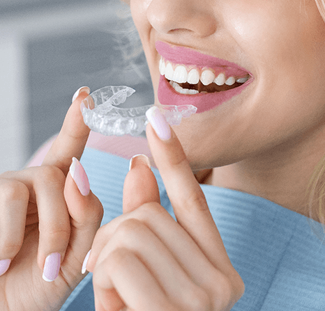 Female student taking off her invisalign